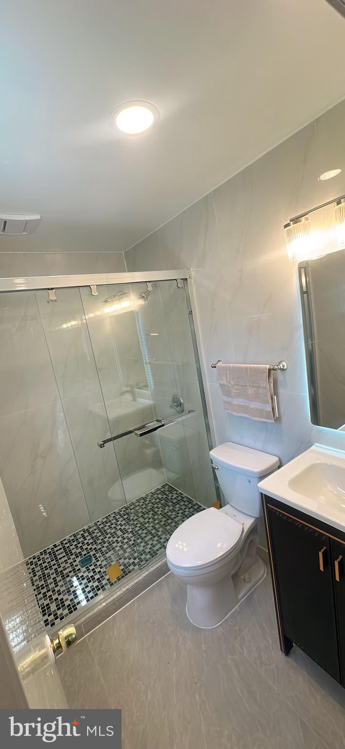 1242 June Road Huntingdon Valley, PA 19006 - Photo 30 of 47 a bathroom with a sink a toilet a rug and shower