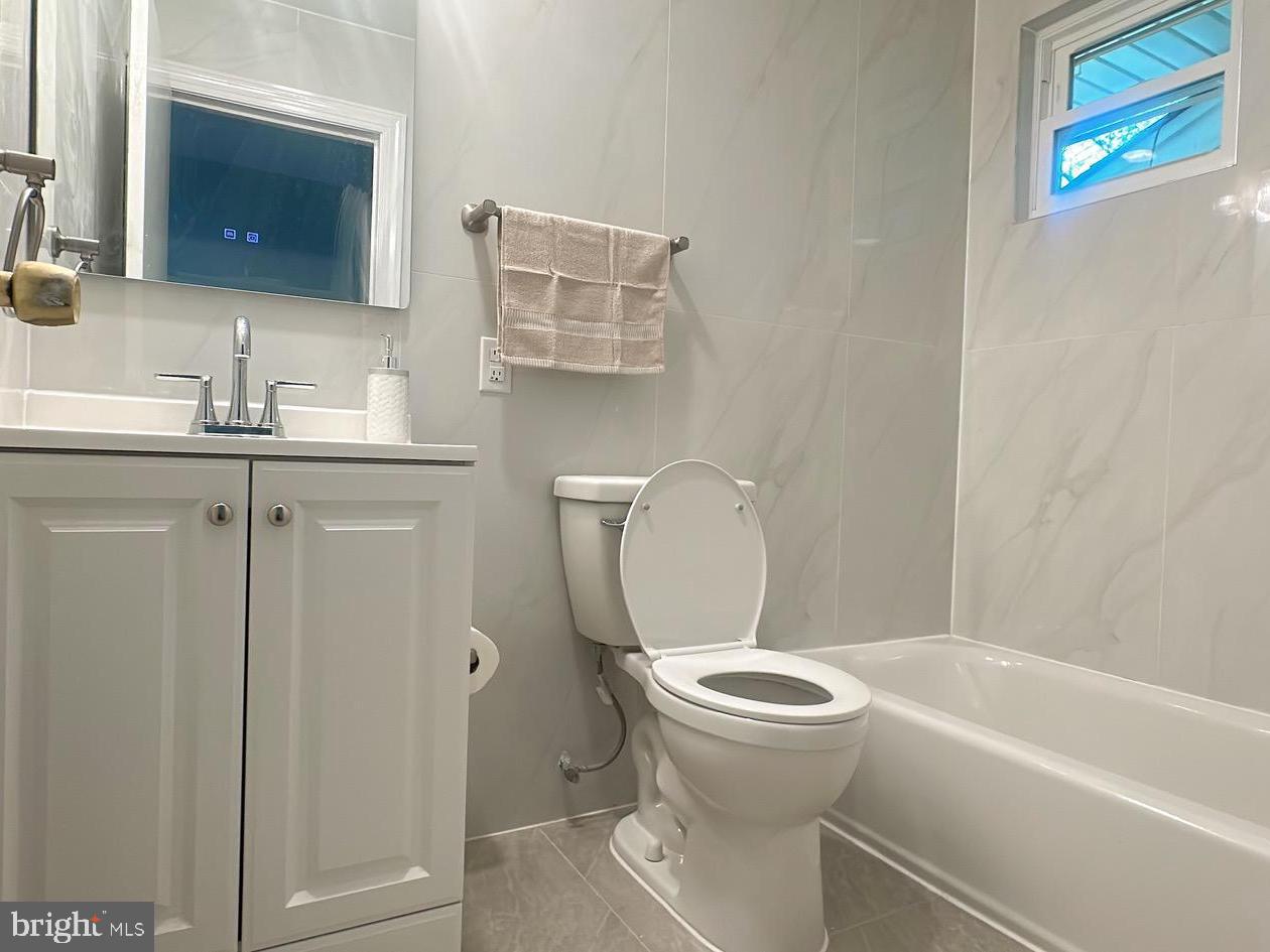 1242 June Road Huntingdon Valley, PA 19006 - Photo 32 of 47 a bathroom with a toilet sink and mirror