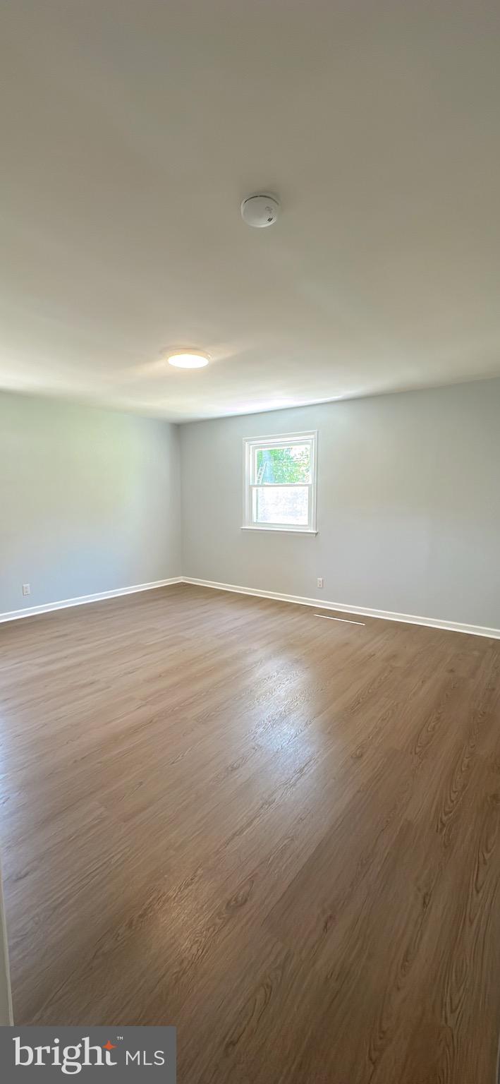 1242 June Road Huntingdon Valley, PA 19006 - Photo 36 of 47 an empty room with wooden floor and windows