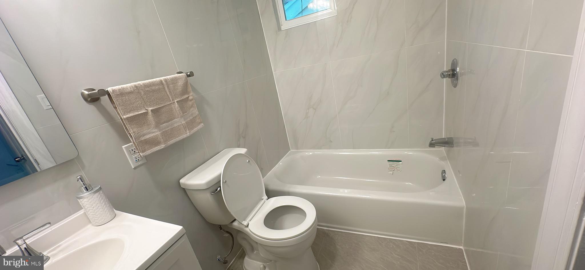 1242 June Road Huntingdon Valley, PA 19006 - Photo 38 of 47 a white toilet sitting next to a bath tub