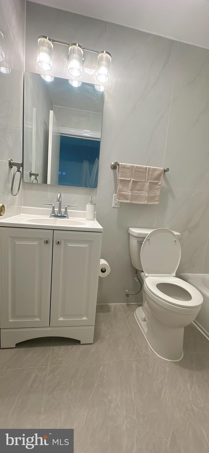 1242 June Road Huntingdon Valley, PA 19006 - Photo 39 of 47 a bathroom with a toilet sink and mirror