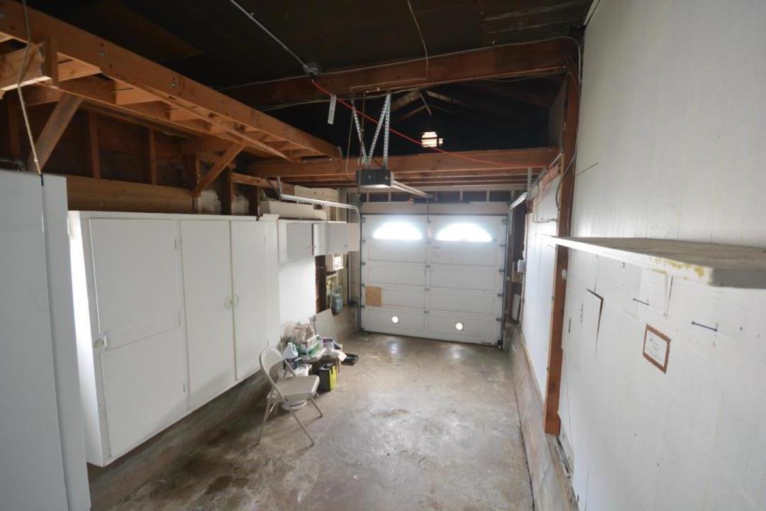 224 Park Boulevard Millbrae, CA 94030 - Photo 15 of 17 a view of a room with water heater and wooden cabinets