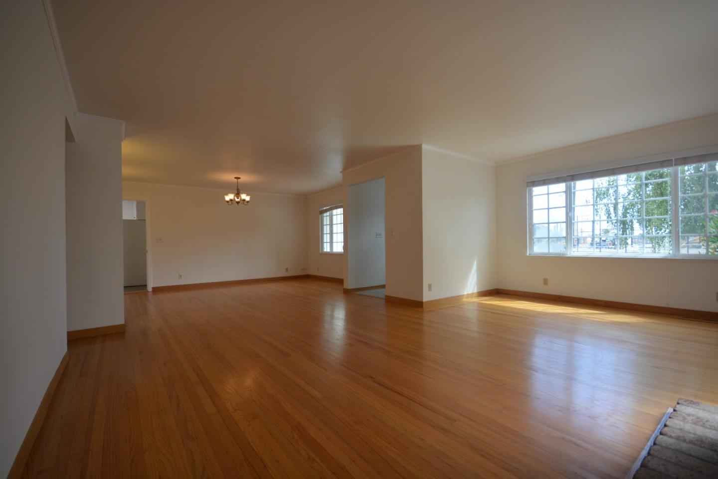 224 Park Boulevard Millbrae, CA 94030 - Photo 4 of 17 a view of an empty room with wooden floor and a window