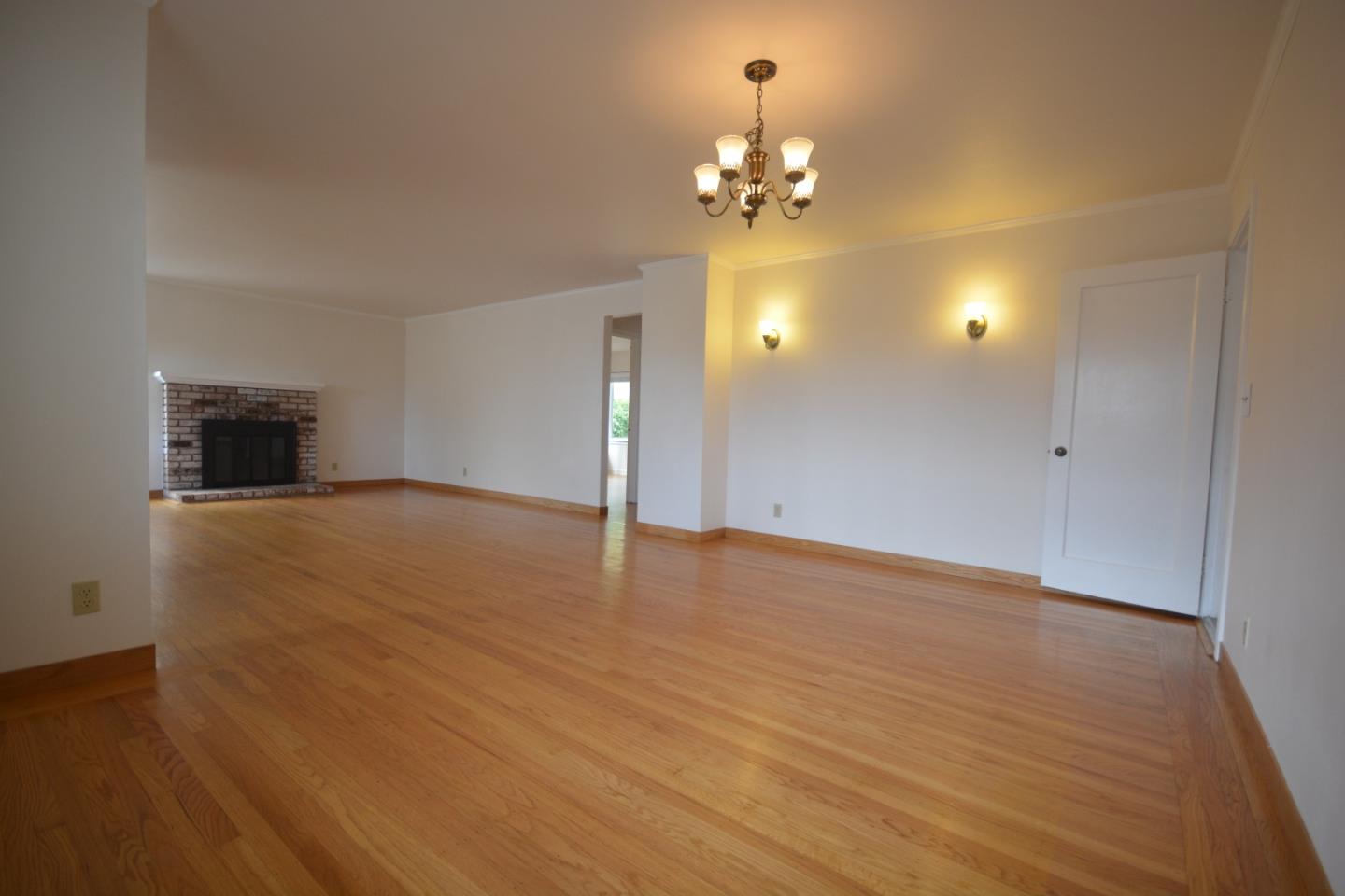 224 Park Boulevard Millbrae, CA 94030 - Photo 5 of 17 a view of empty room with wooden floor and chandelier