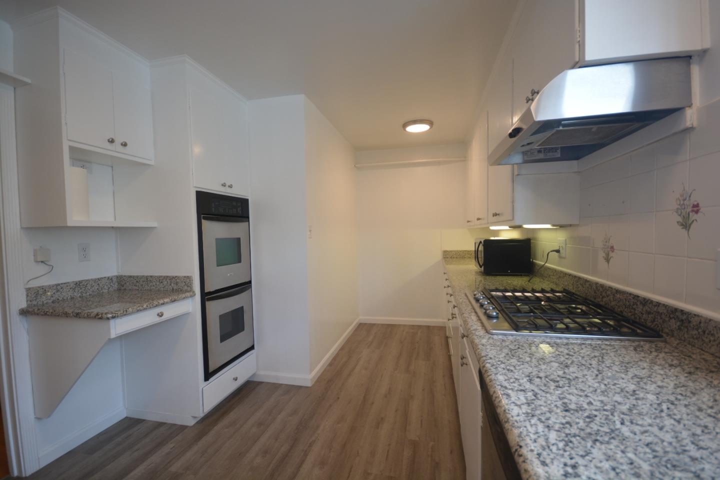 224 Park Boulevard Millbrae, CA 94030 - Photo 7 of 17 a kitchen with granite countertop a stove and a refrigerator