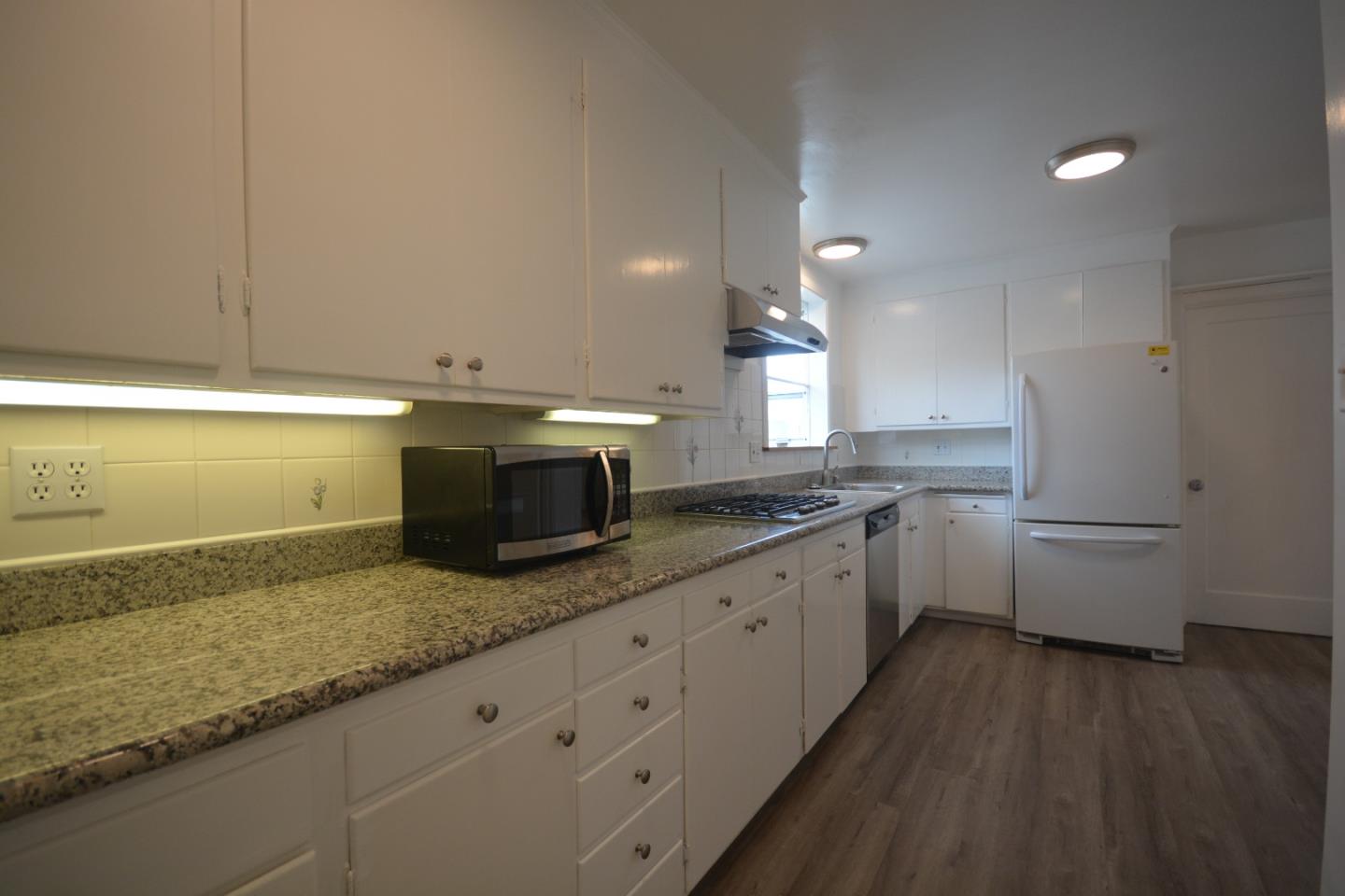 224 Park Boulevard Millbrae, CA 94030 - Photo 8 of 17 a kitchen with granite countertop white cabinets and white appliances