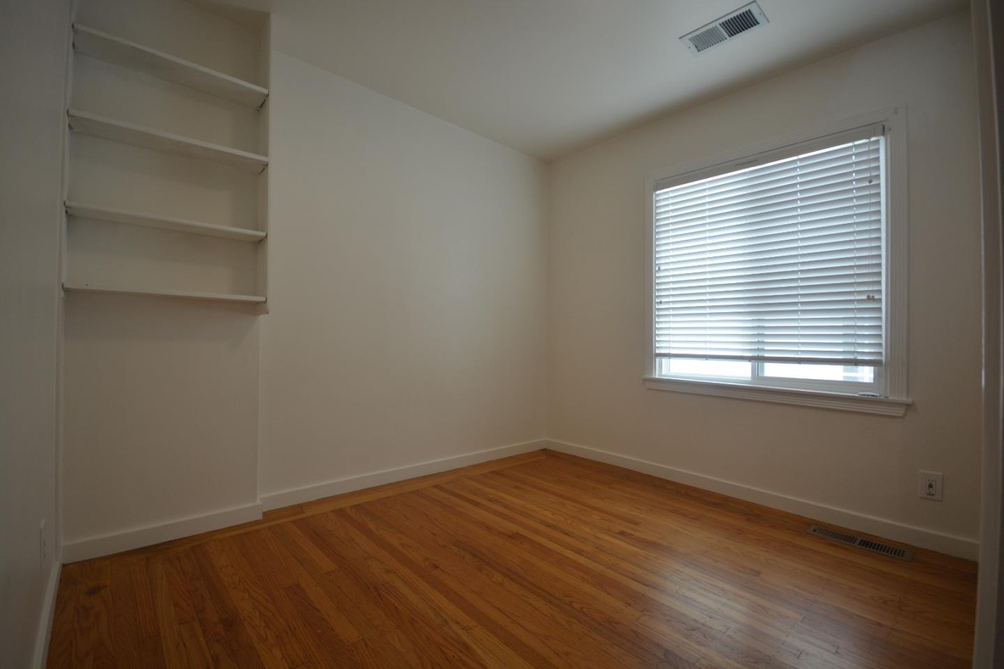 224 Park Boulevard Millbrae, CA 94030 - Photo 10 of 17 a view of an empty room with a window and wooden floor