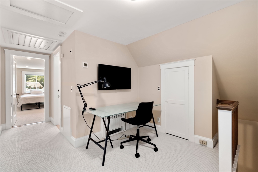 39 Ingraham Road Wellesley, MA 02482 - Photo 22 of 30 a view of a workspace with furniture and a flat screen tv