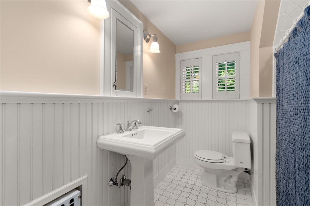 39 Ingraham Road Wellesley, MA 02482 - Photo 23 of 30 a bathroom with a sink a toilet and mirror