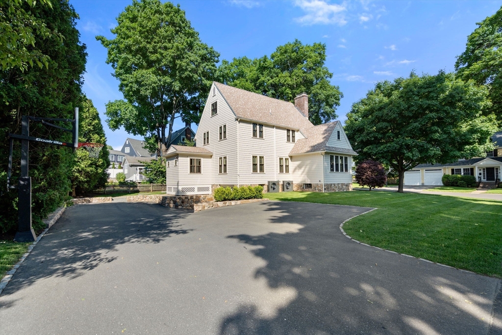 39 Ingraham Road Wellesley, MA 02482 - Photo 26 of 30 a view of a white house with a big yard and large trees