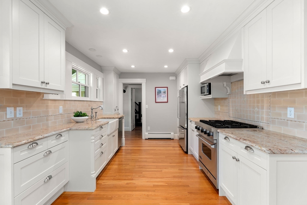 39 Ingraham Road Wellesley, MA 02482 - Photo 7 of 30 a kitchen with stainless steel appliances granite countertop a stove and a sink