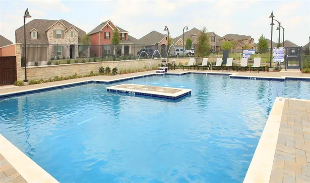 a view of a swimming pool with outdoor seating