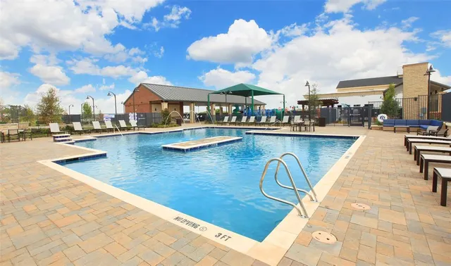 a view of a swimming pool with a backyard