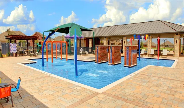 a view of a swimming pool with an outdoor seating