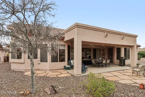 a view of a patio with a dining table and chairs
