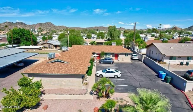 a view of a houses with a yard and a garden