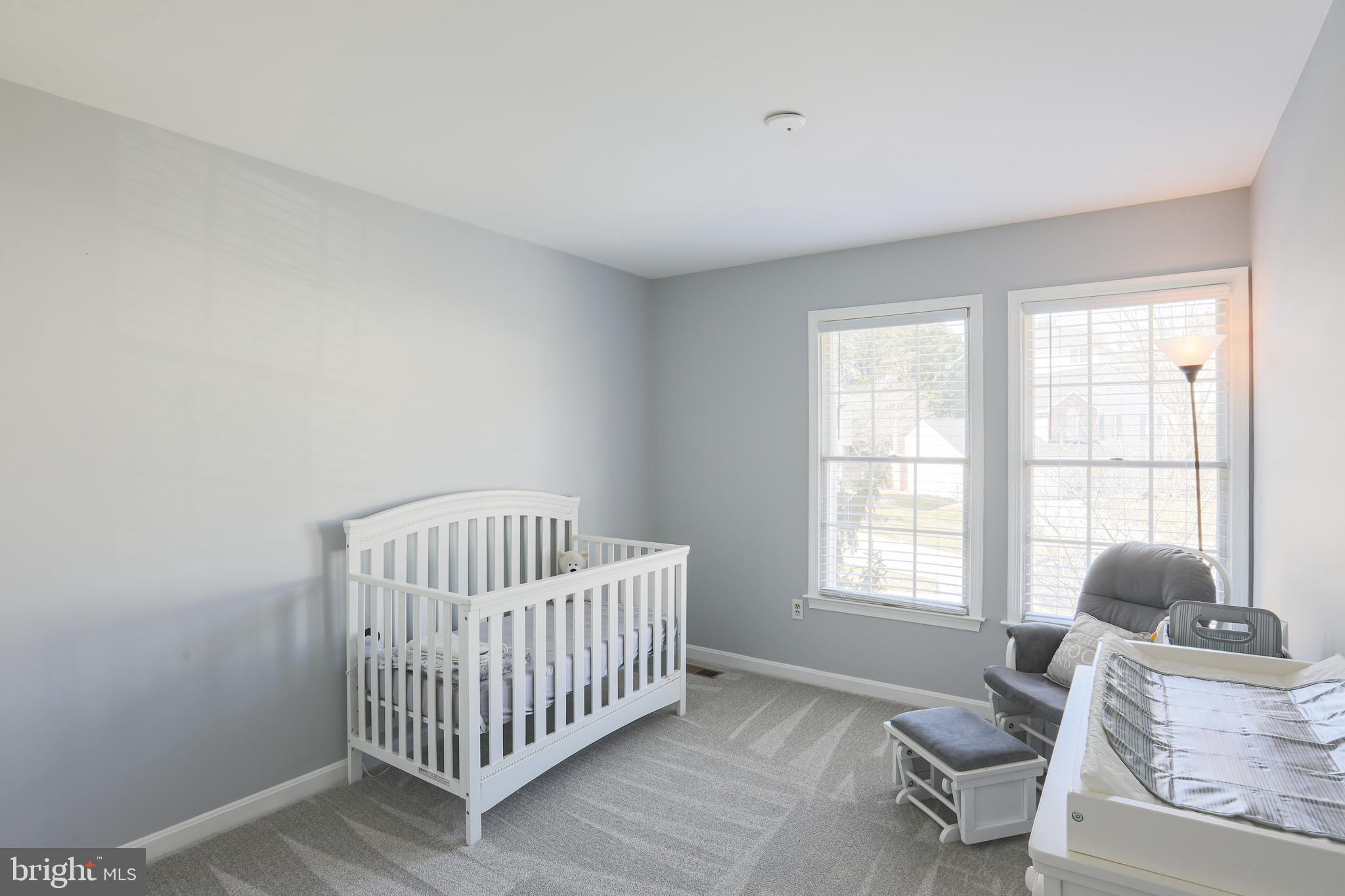 9547 Hallhurst Road Baltimore, MD 21236 - Photo 39 of 49 a bedroom with a bed and wooden floor