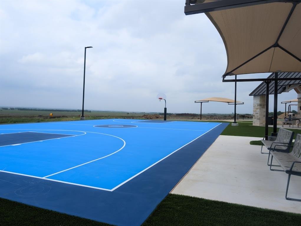 564 Rancho Del Cielo Loop Jarrell, TX 76537 - Photo 13 of 14 An outdoor basketball court offers ample space for recreation and enjoyment.
