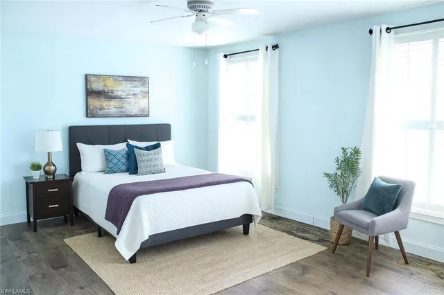 a spacious bedroom with a bed and a chair