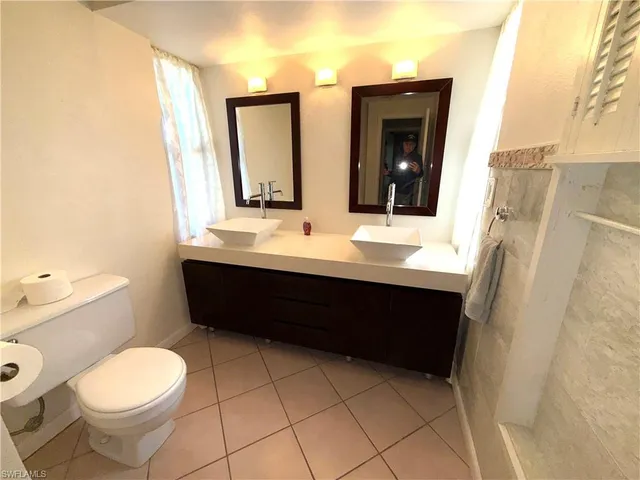 a bathroom with a sink shower and a mirror