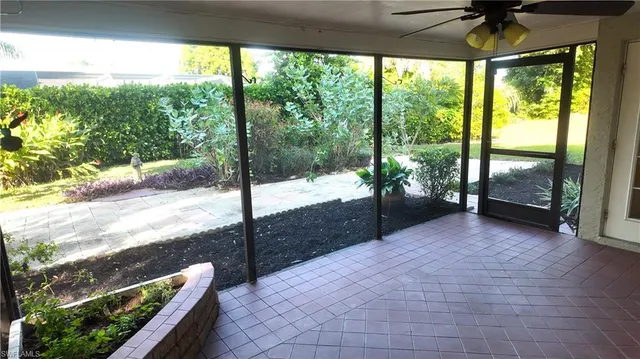 a view of a house with potted plants