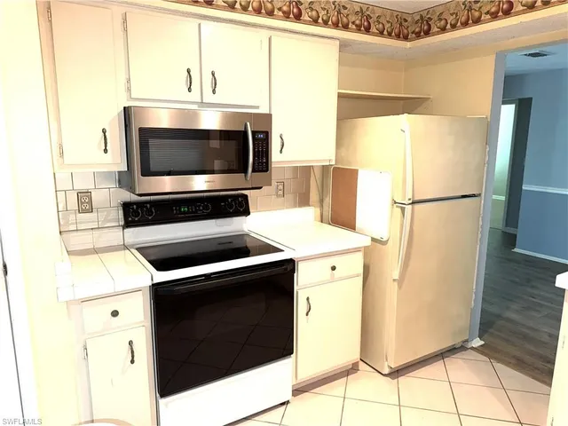a kitchen with a sink a stove and a refrigerator