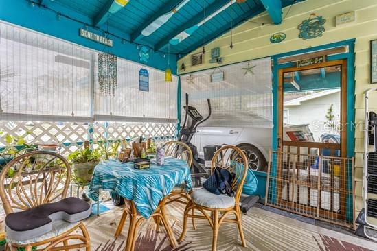 4544 Cynthia Lane Spring Hill, FL 34606 - Photo 12 of 35 a view of a patio with table and chairs with wooden floor