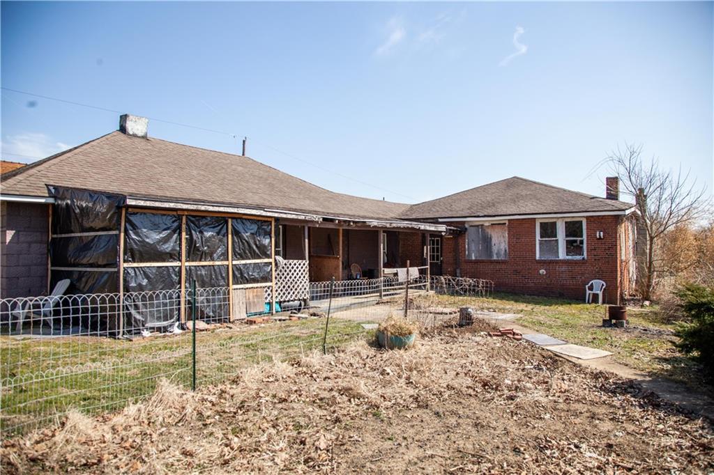 107 Madison Road Grindstone, PA 15442 - Photo 12 of 14 a front view of a house with a yard patio and fire pit