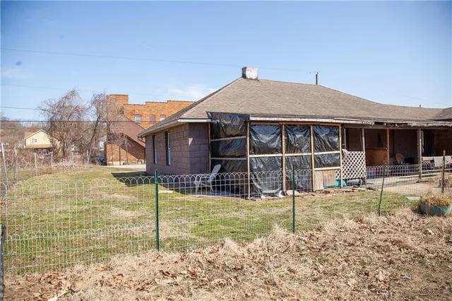 a view of a house with backyard porch and sitting area