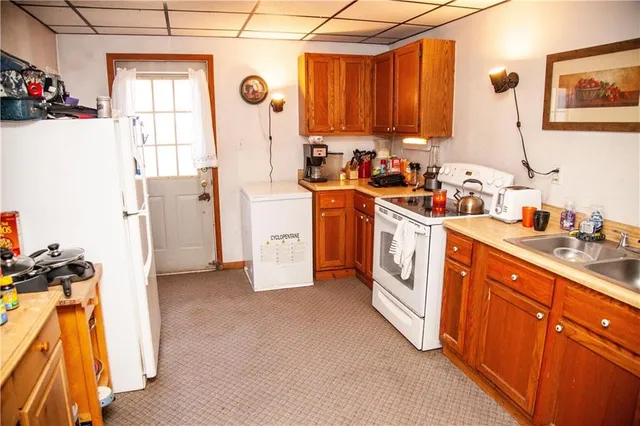 a kitchen with appliances a sink and a cabinets