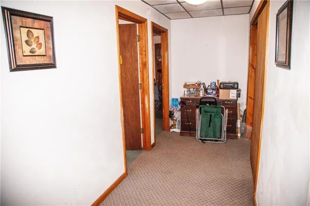 a view of hallway with furniture and a window