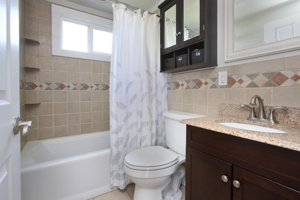 44 Brae Road Weymouth, MA 02191 - Photo 11 of 24 a bathroom with a granite countertop toilet sink and mirror