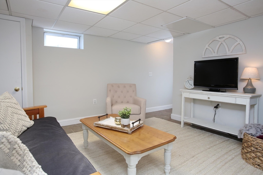 44 Brae Road Weymouth, MA 02191 - Photo 21 of 24 a living room with furniture and a flat screen tv