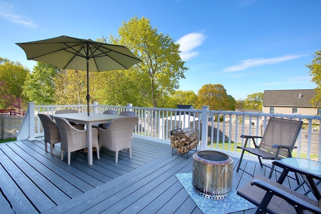 44 Brae Road Weymouth, MA 02191 - Photo 22 of 24 a patio with wooden floor a yard a table and chairs