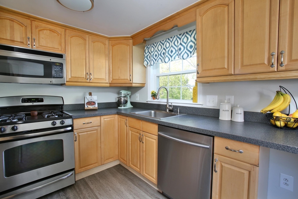 44 Brae Road Weymouth, MA 02191 - Photo 3 of 24 a kitchen with stainless steel appliances granite countertop a sink a stove and a microwave