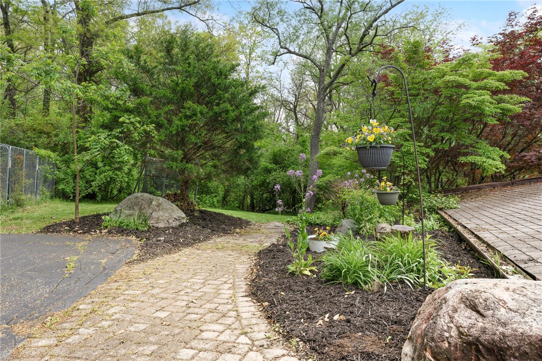 1940 Armstrong Road Fairborn, OH 45324 - Photo 5 of 48 A charming brick pathway leads through a lush, verdant garden.