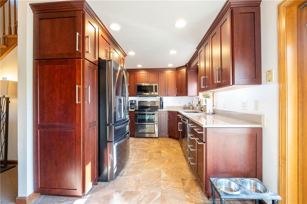 287 Ruffsdale Road Ruffs Dale, PA 15679 - Photo 6 of 21 a kitchen with stainless steel appliances granite countertop a refrigerator a sink and a stove