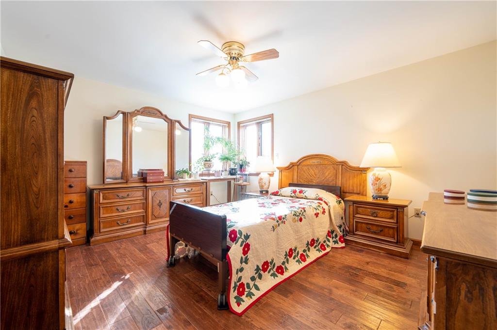 287 Ruffsdale Road Ruffs Dale, PA 15679 - Photo 8 of 21 a bedroom with a bed and a chandelier