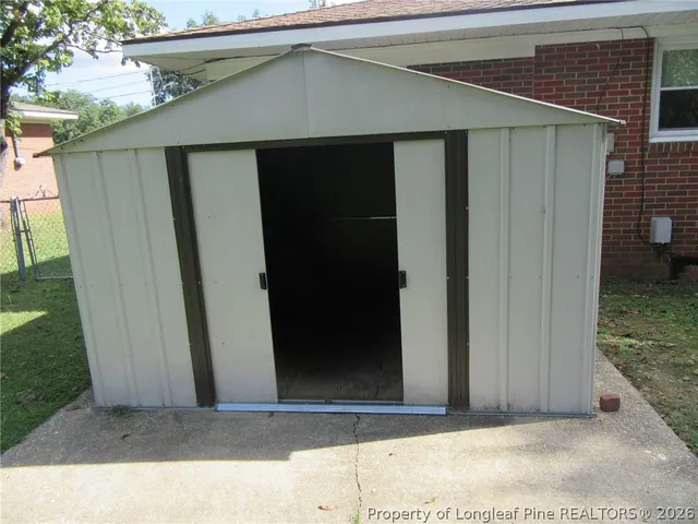 a black car parked in front of a house
