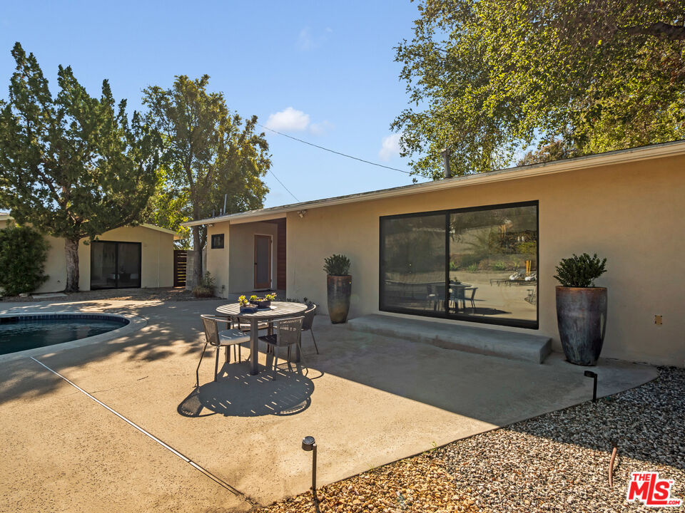 26077 Farmfield Road Calabasas, CA 91302 - Photo 36 of 45 a view of a patio with table and chairs potted plants and large tree