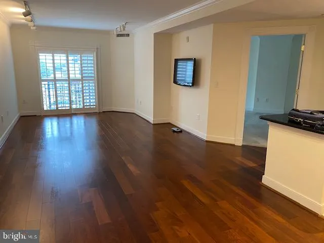 a view of a livingroom with wooden floor and a window