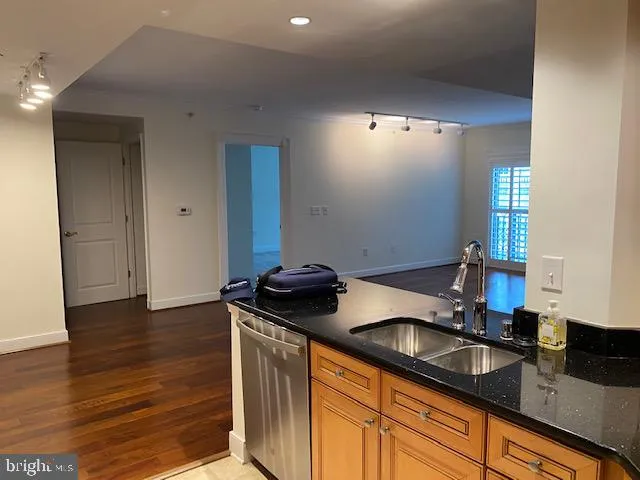 a kitchen with granite countertop a sink and cabinets