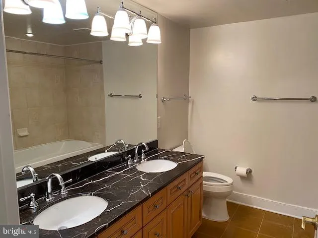 a bathroom with a sink a toilet a mirror and vanity