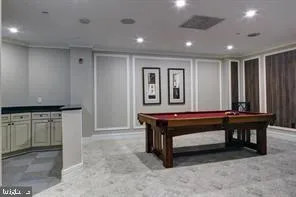 a room with furniture pool table and projector