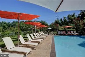 a view of a swimming pool with lounge chairs in patio