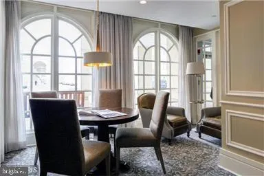 a view of a dining room with furniture and a window