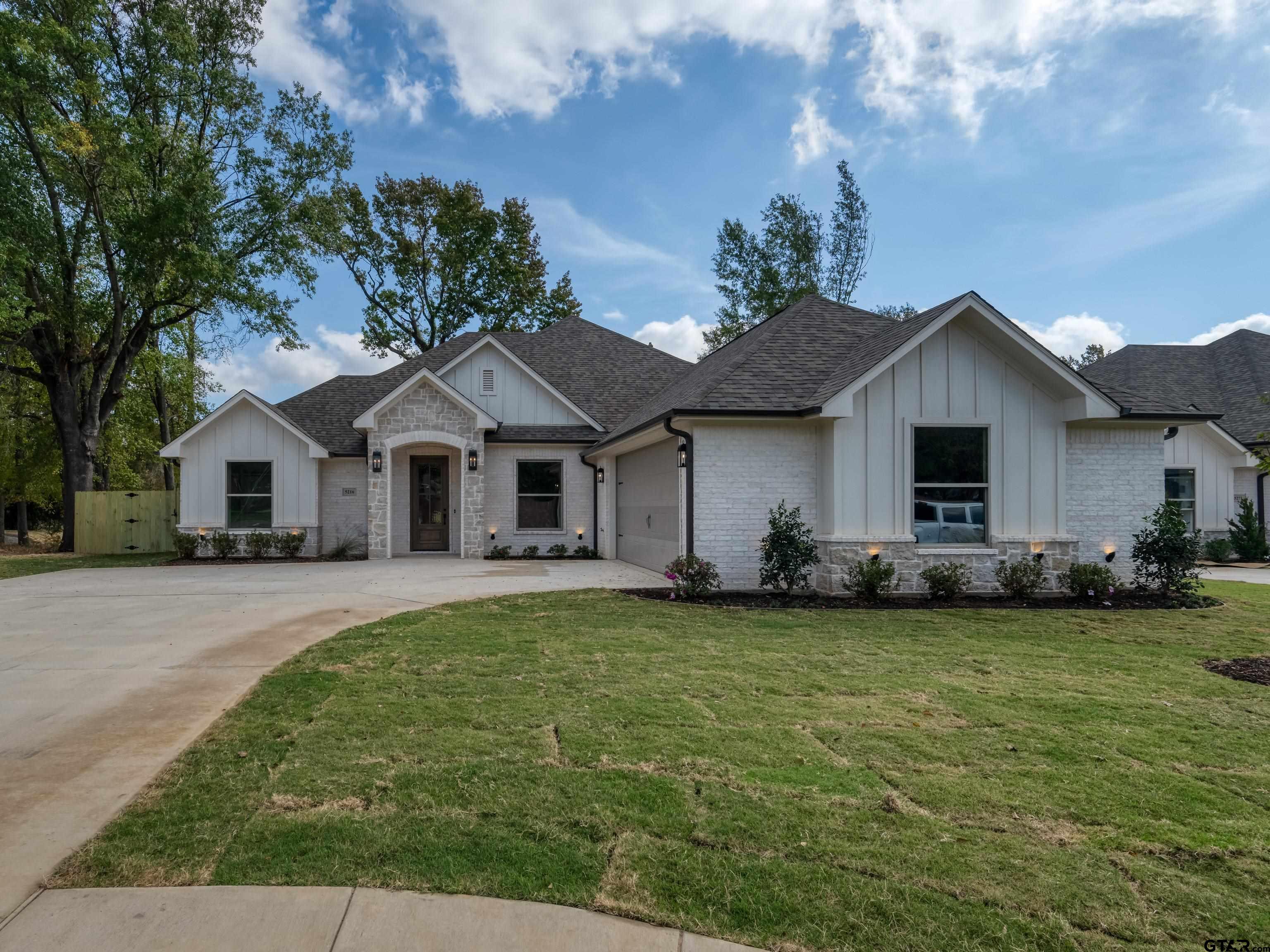 5216 Hollytree Drive Tyler, TX 75703 - Photo 2 of 28 a front view of a house with a garden