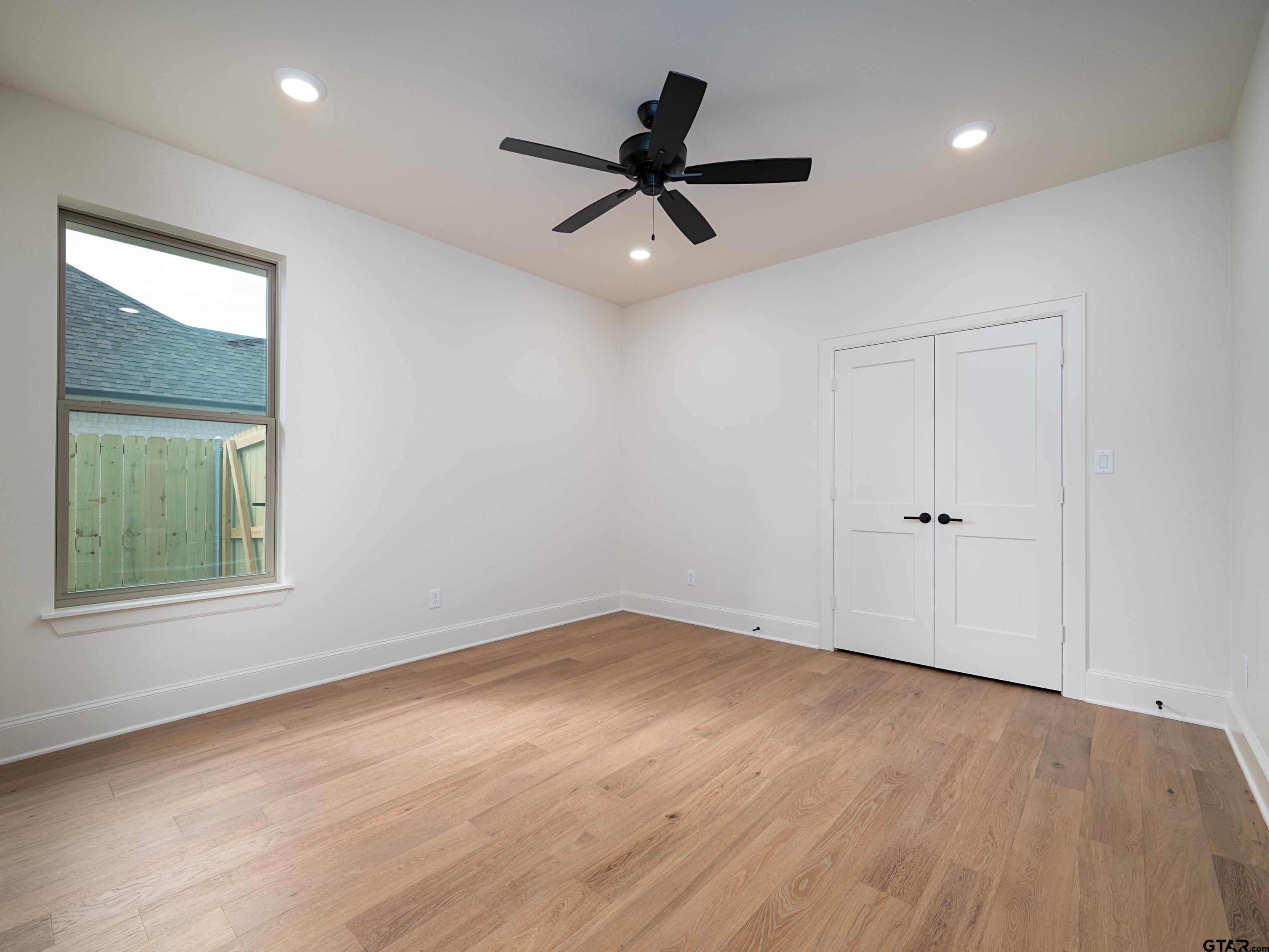 5216 Hollytree Drive Tyler, TX 75703 - Photo 22 of 28 wooden floor in an empty room with a window