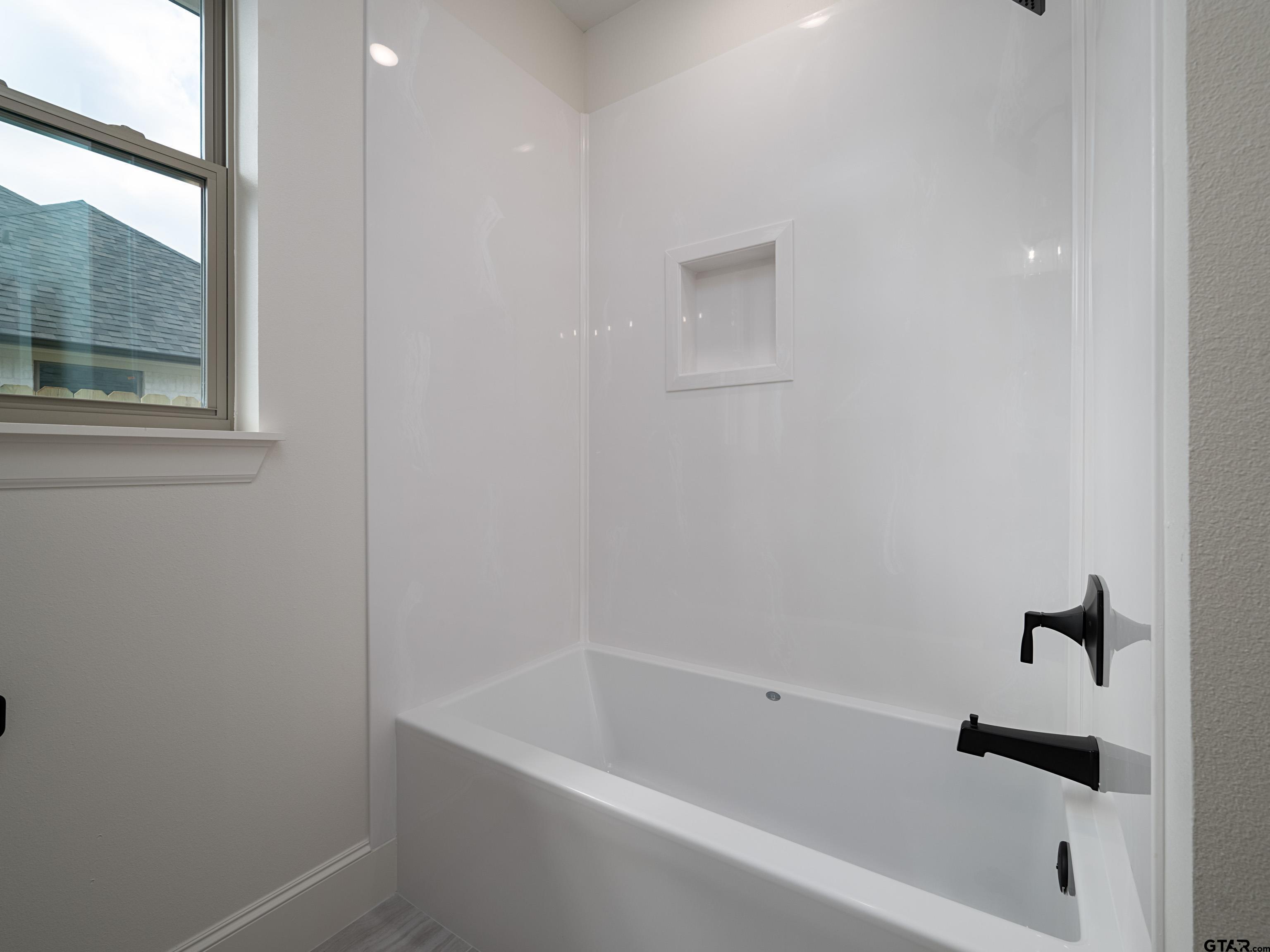 5216 Hollytree Drive Tyler, TX 75703 - Photo 24 of 28 a bathroom with a bathtub