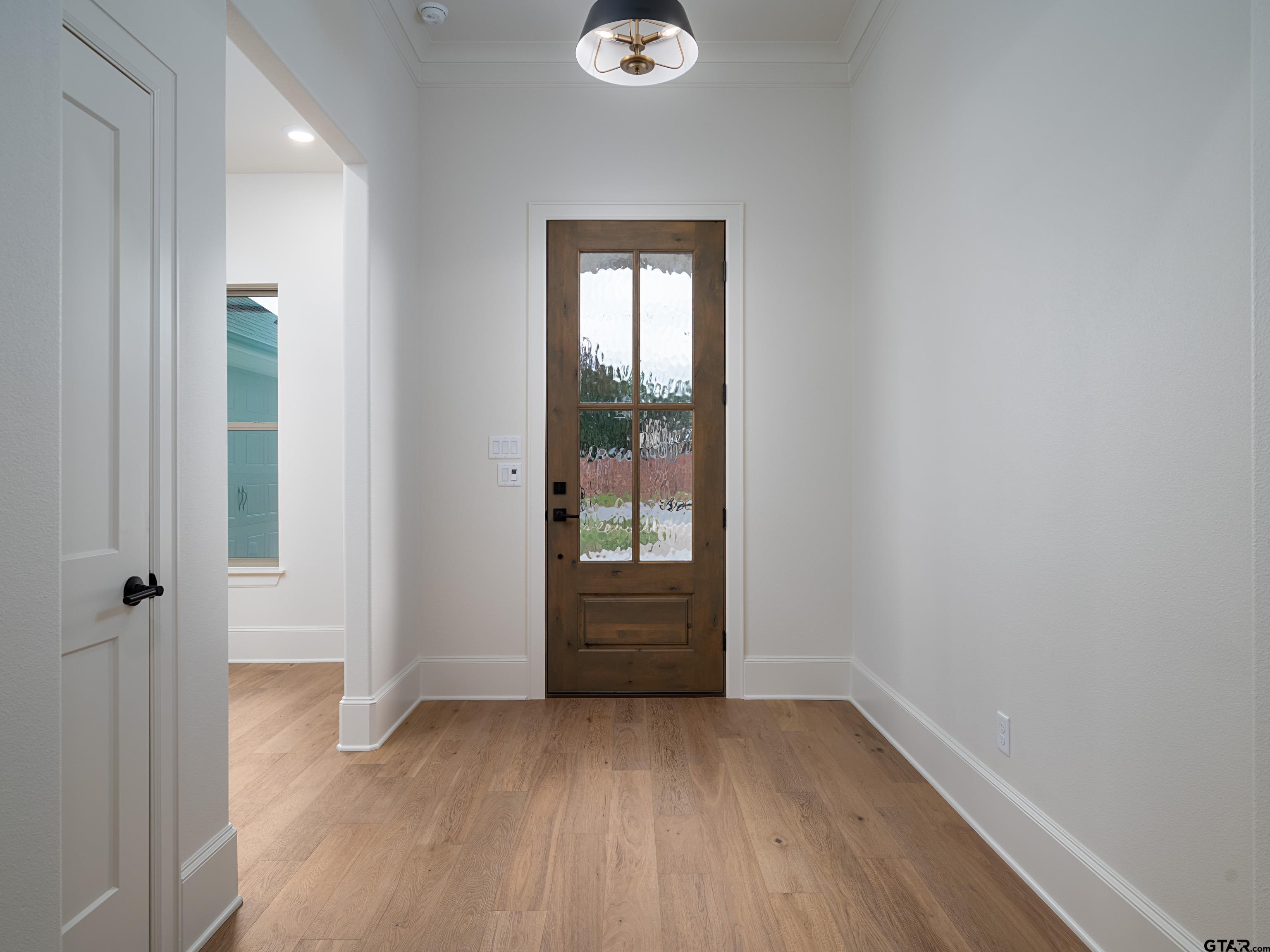 5216 Hollytree Drive Tyler, TX 75703 - Photo 4 of 28 an empty room with wooden floor and windows